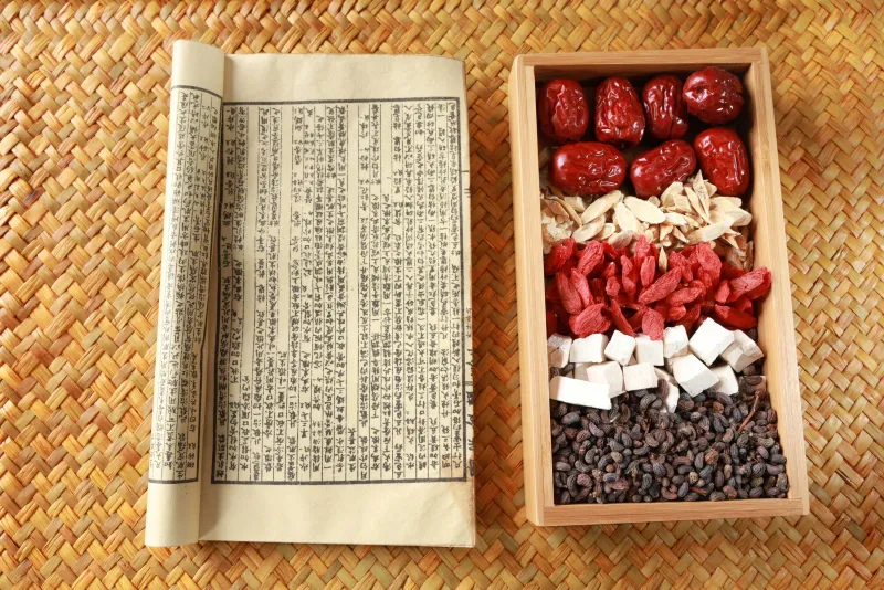 Ancient Chinese herbal medicine scroll with traditional ingredients