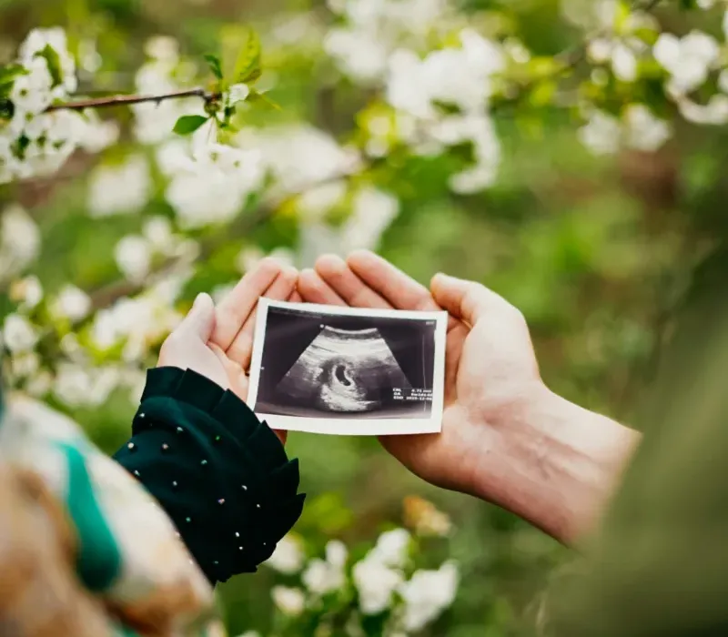 Woman holding ultrasound photo